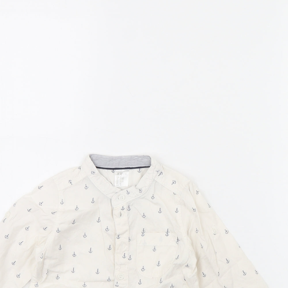 Close-up detail of H&M girls’ white spotted basic button-up, size 12, months
