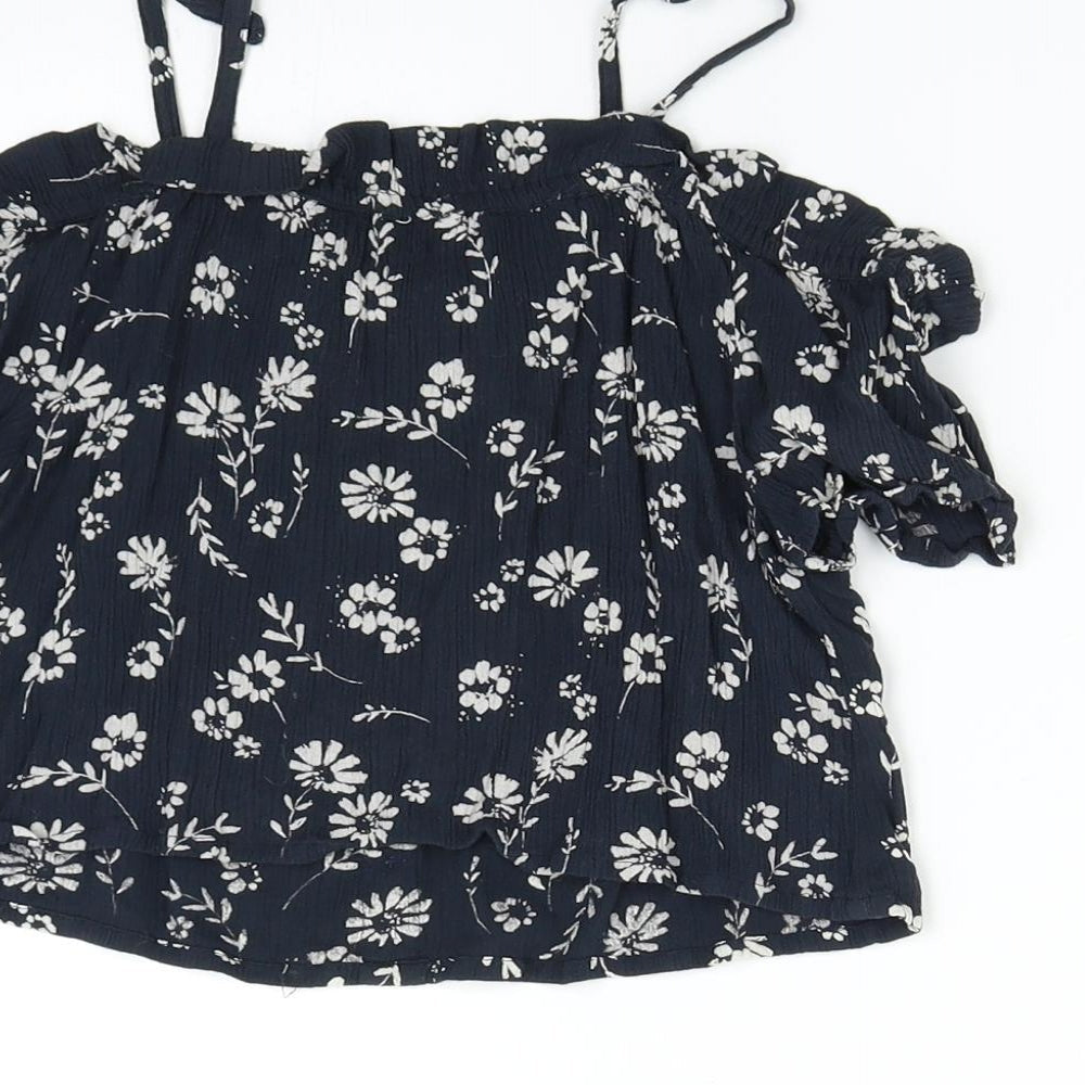 Brand and care label for Next girls’ blue floral basic blouse, size 8, years