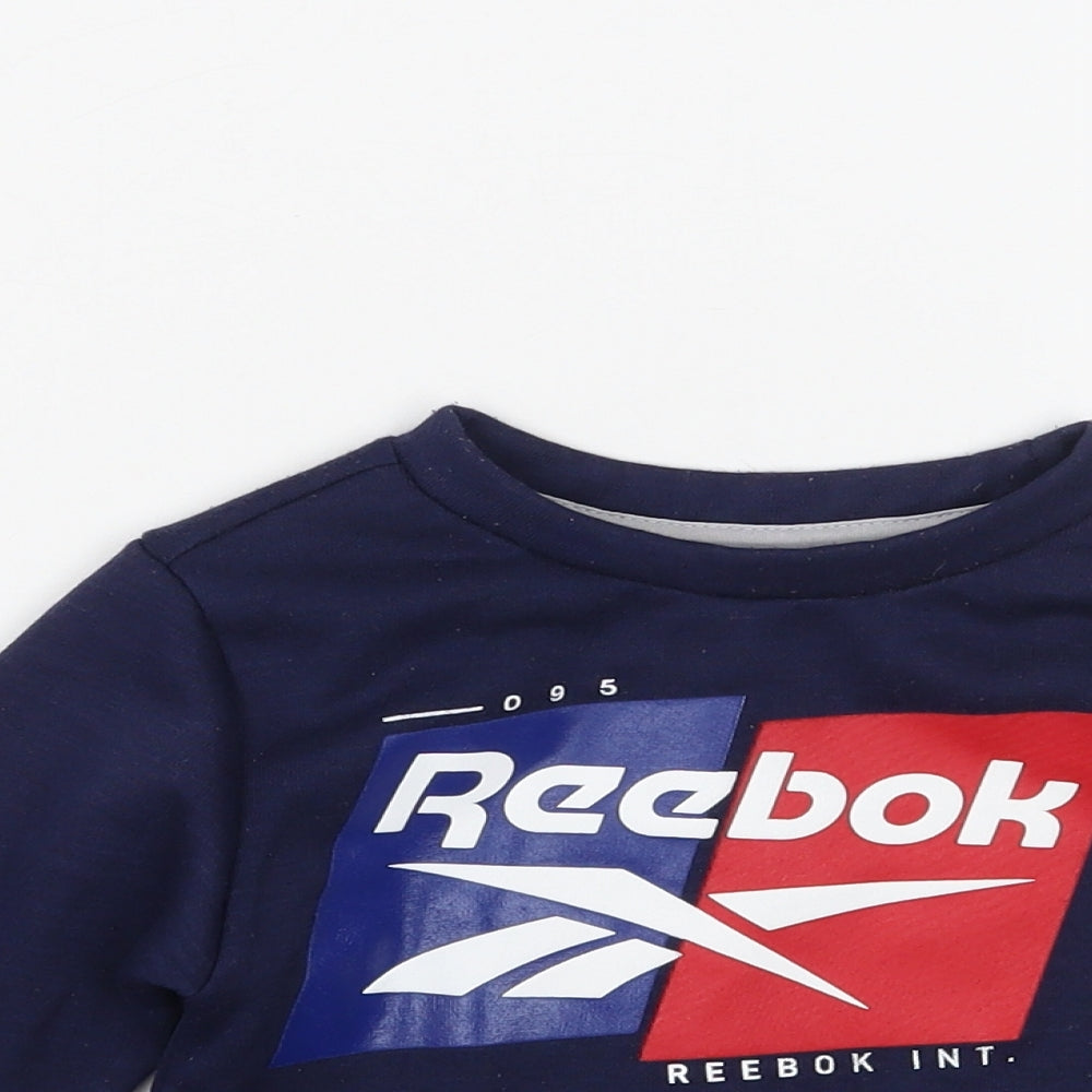 Close-up detail of Reebok boys’ blue jumper, size 18-24, months