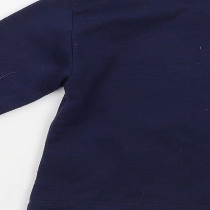 Brand and care label for Reebok boys’ blue jumper, size 18-24, months