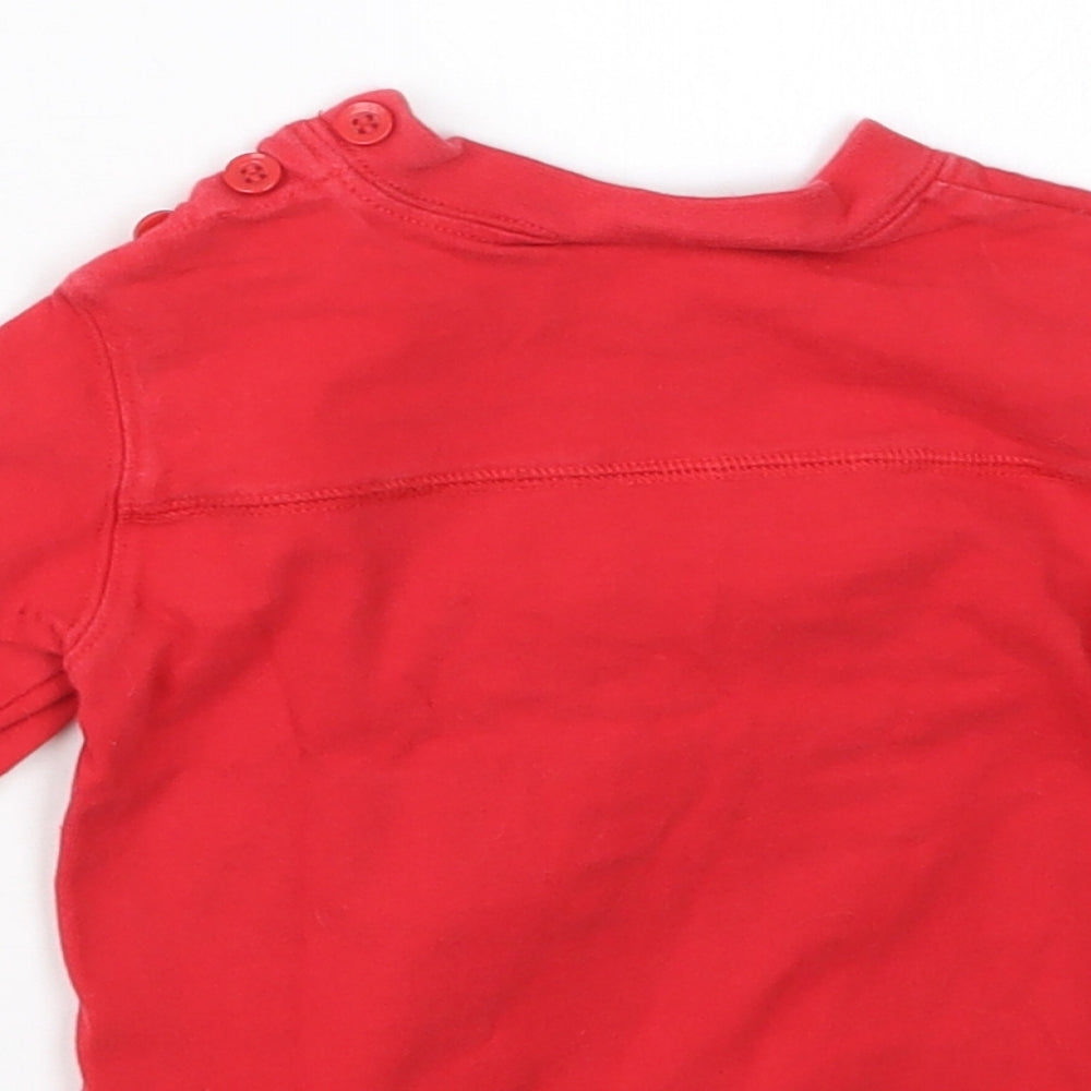 Brand and care label for Ladybird boys’ red jumper, size 6-9, months