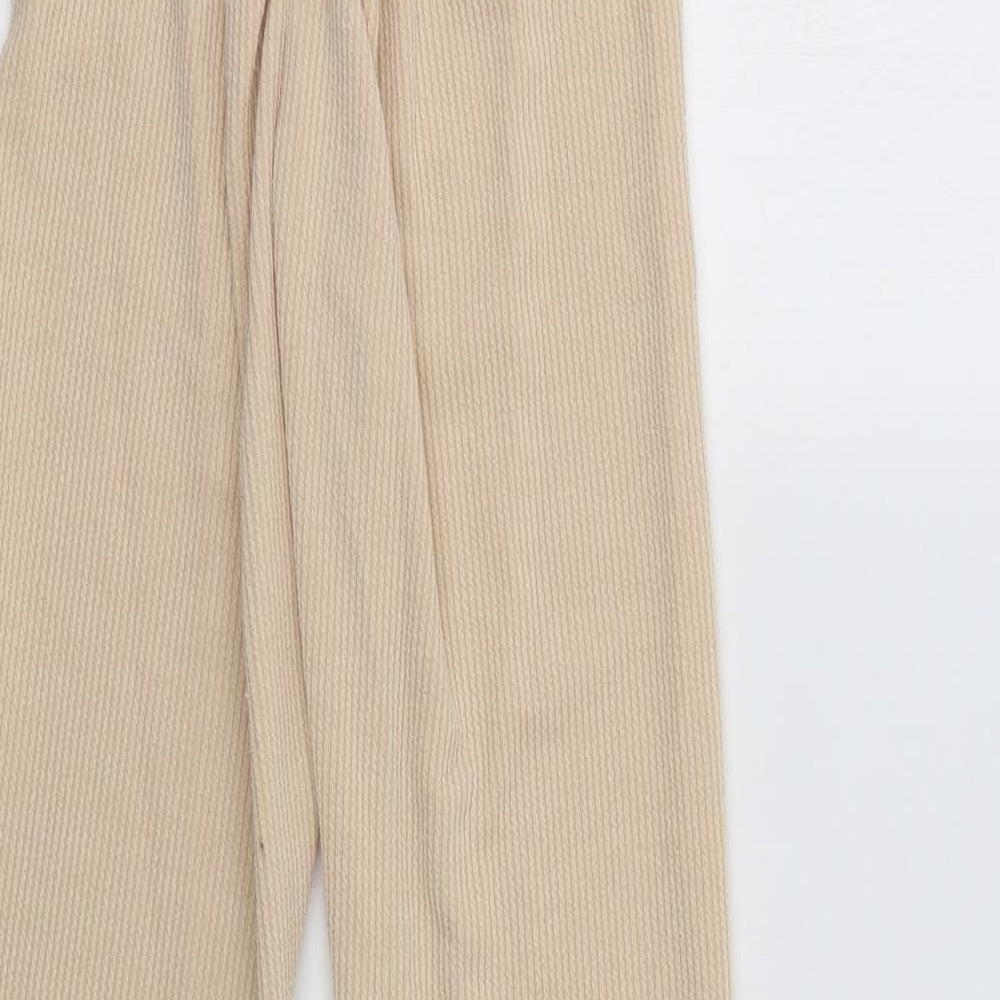 Brand and care label for PRETTYLITTLETHING women’s beige lounge pants, size UK 10