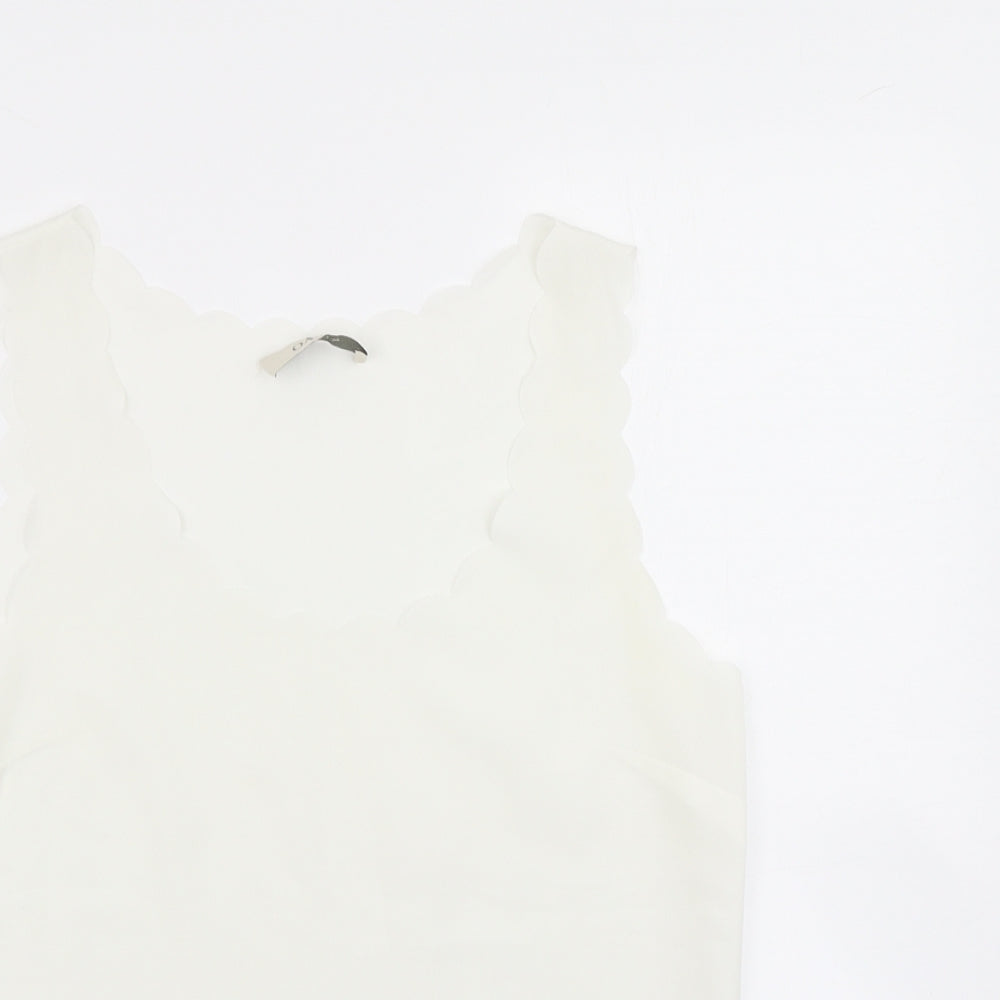 Close-up detail of OPasis women’s ivory basic blouse, size UK 10, - scalloped hem