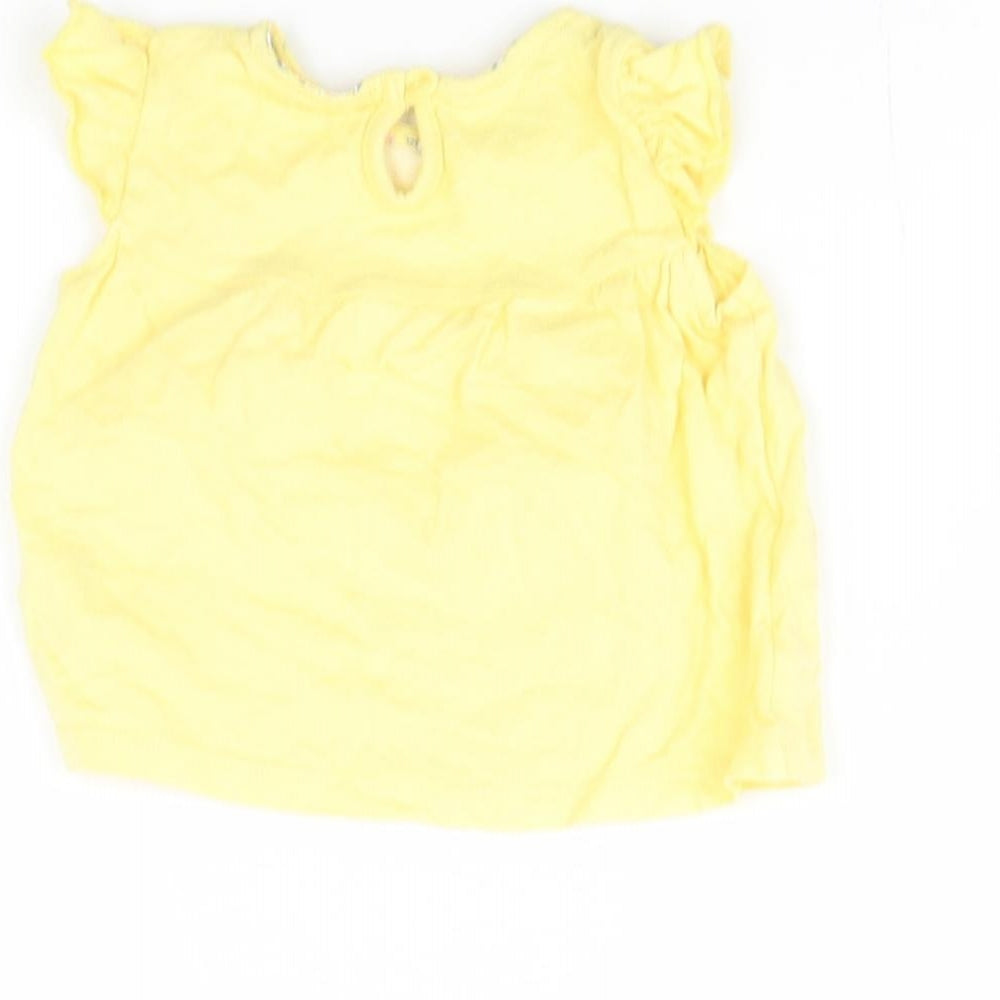 Brand and care label for F&F girls’ yellow basic blouse, size 0-3, months