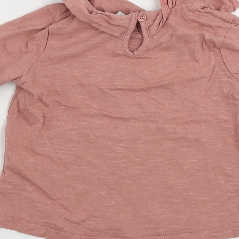 Brand and care label for Tu girls’ pink basic t-shirt, size 2-3, years