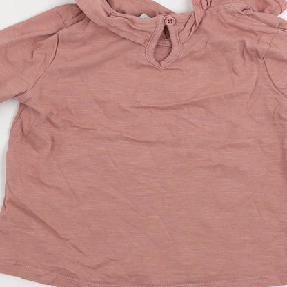 Brand and care label for Tu girls’ pink basic t-shirt, size 2-3, years