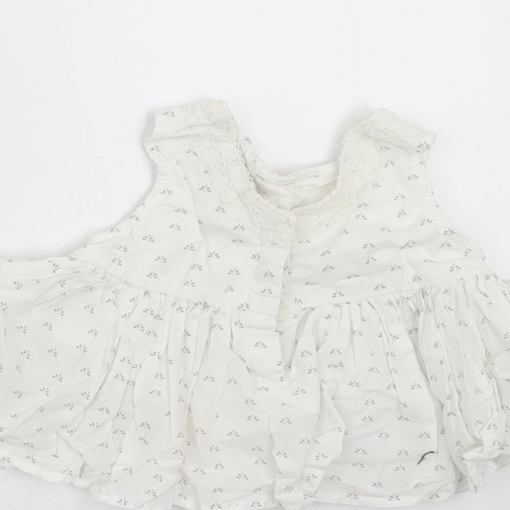 Brand and care label for Next girls’ white floral basic blouse, size 3-6, months