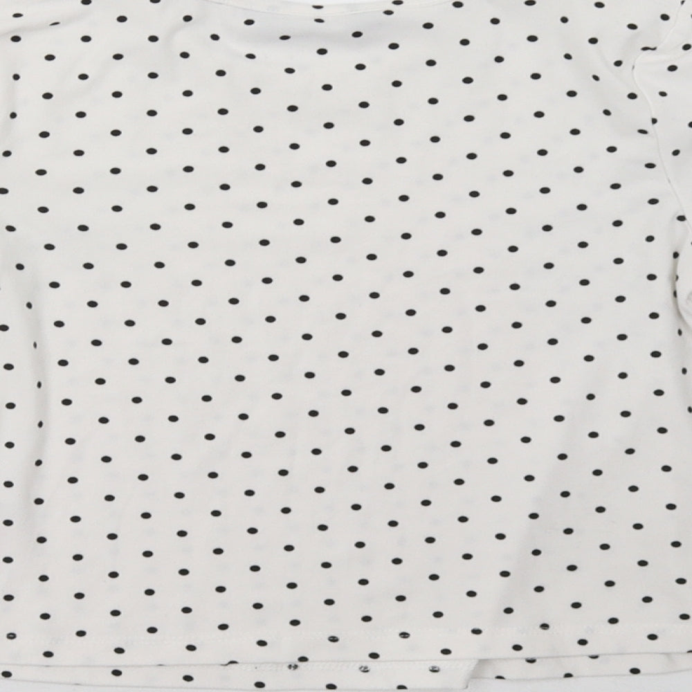 Brand and care label for Primark girls’ white polka dot pullover sweatshirt, size 7-8, years
