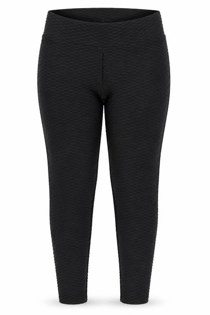 Front view of Preworn women’s black geometric jegging trousers, size L, 28-inch leg - raised weave texture ruched seat