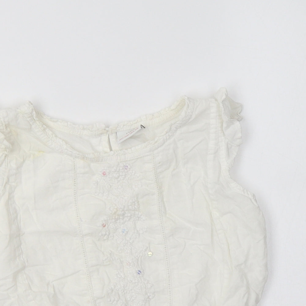 Close-up detail of Next girls’ white cotton basic blouse, size 6, years crew neck