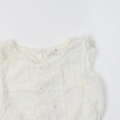 Close-up detail of Next girls’ white cotton basic blouse, size 6, years crew neck