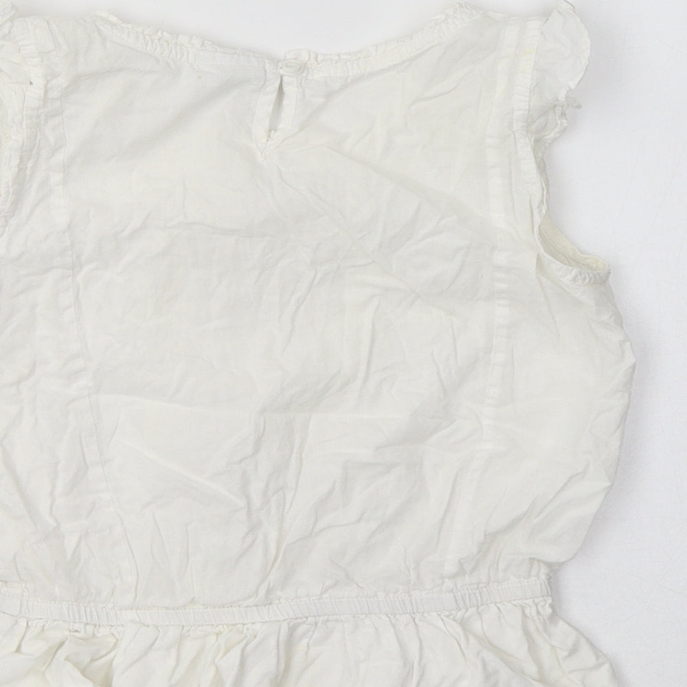 Brand and care label for Next girls’ white cotton basic blouse, size 6, years crew neck