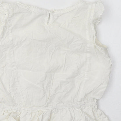 Brand and care label for Next girls’ white cotton basic blouse, size 6, years crew neck
