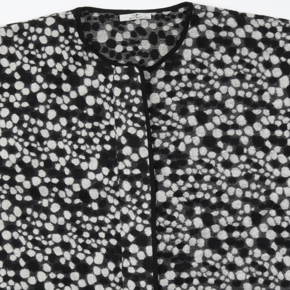 Close-up detail of LADY DISTRICT women’s multicoloured polka dot poncho, size UK 18