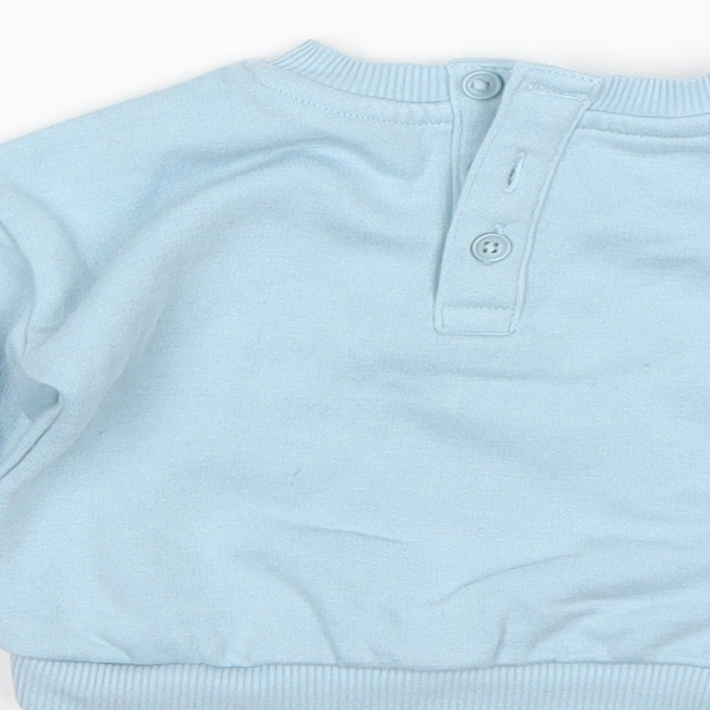 Brand and care label for Matalan boys’ blue polyester jumper, size 0-3, months