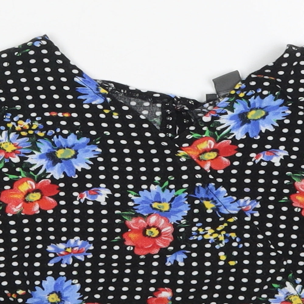 Close-up detail of Primark girls’ multicoloured polka dot viscose basic blouse, size 9-10, years v-neck pullover - flowers