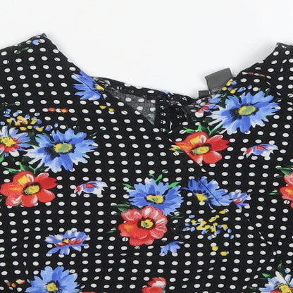 Close-up detail of Primark girls’ multicoloured polka dot viscose basic blouse, size 9-10, years v-neck pullover - flowers