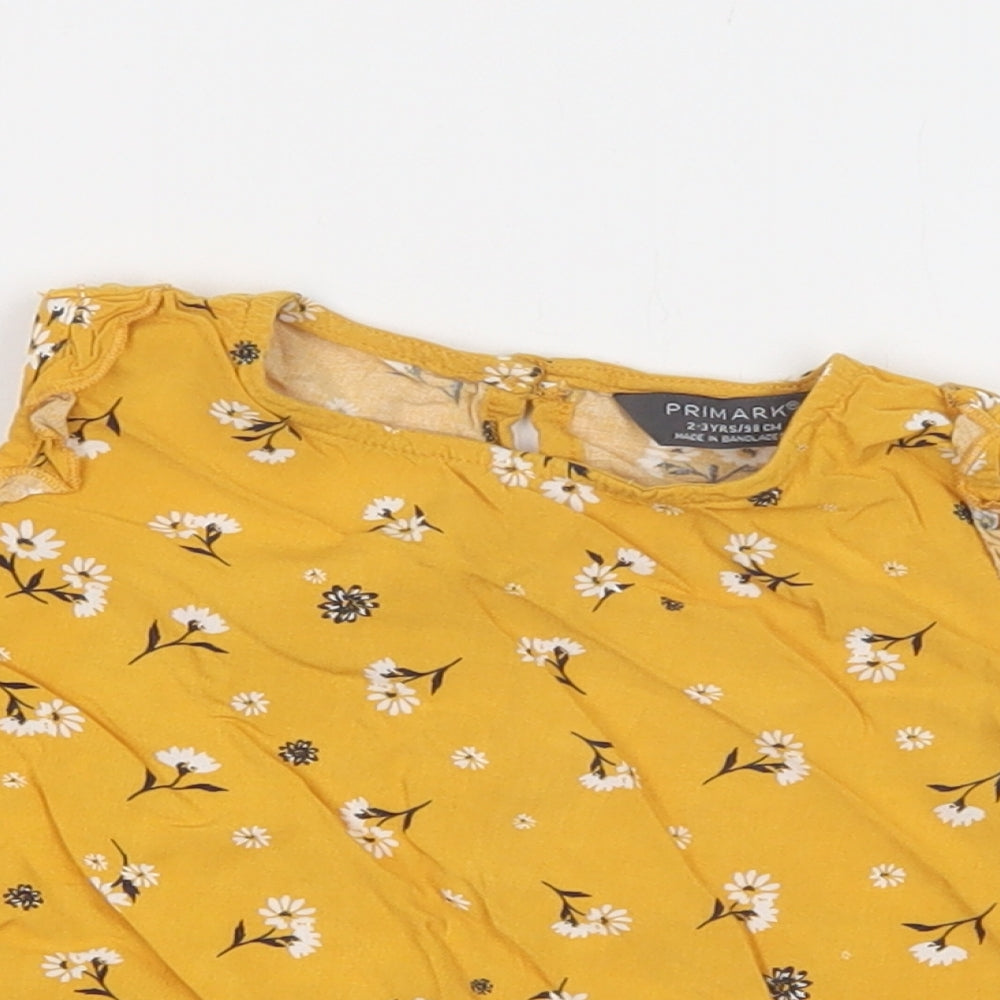 Close-up detail of Primark girls’ yellow floral viscose basic blouse, size 2-3, years crew neck button