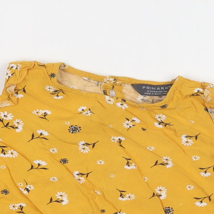 Close-up detail of Primark girls’ yellow floral viscose basic blouse, size 2-3, years crew neck button