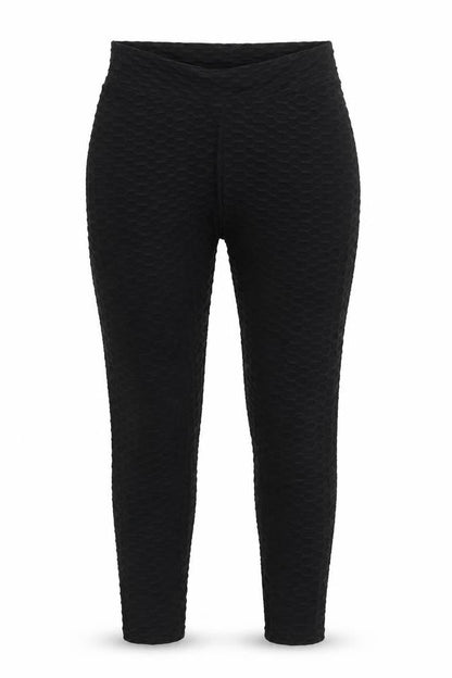 Front view of Preworn women’s black nylon carrot leggings, size L, 29-inch leg