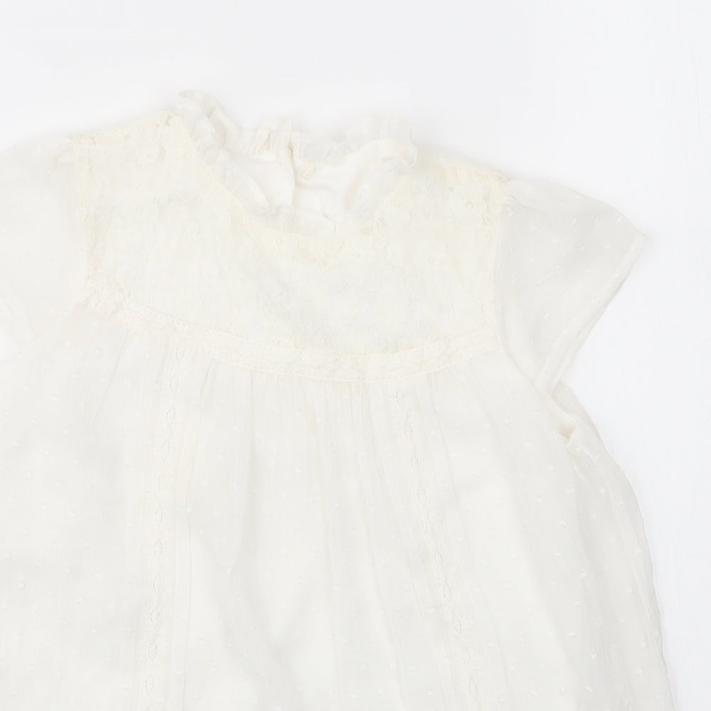 Close-up detail of George girls’ white nylon basic blouse, size 7, years round neck button