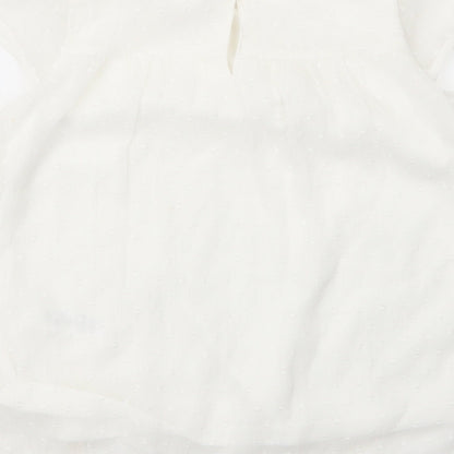 Brand and care label for George girls’ white nylon basic blouse, size 7, years round neck button
