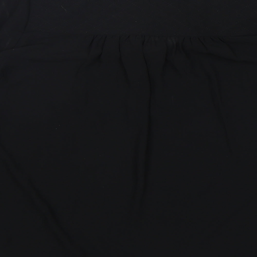 Brand and care label for Love 21 women’s black polyester basic blouse, size XS, v-neck