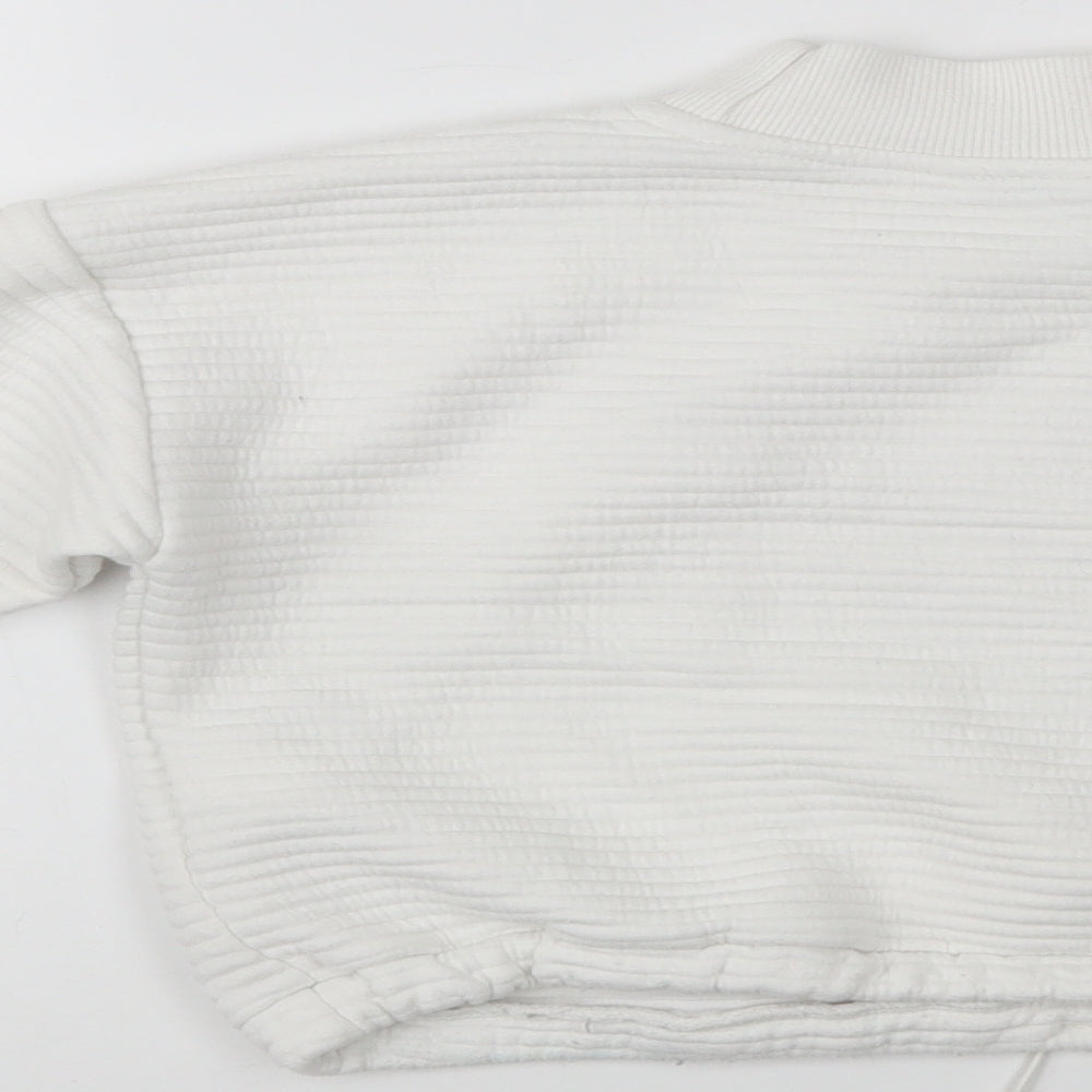 Brand and care label for Primark girls’ white polyester pullover sweatshirt, size 9-10, years