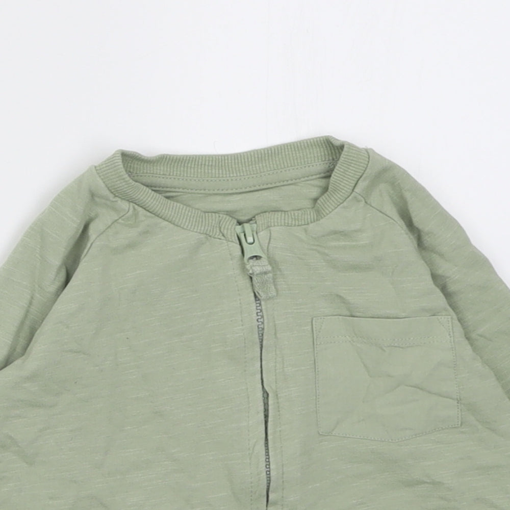 Close-up detail of Matalan girls’ green jacket, size 9-12, months zip