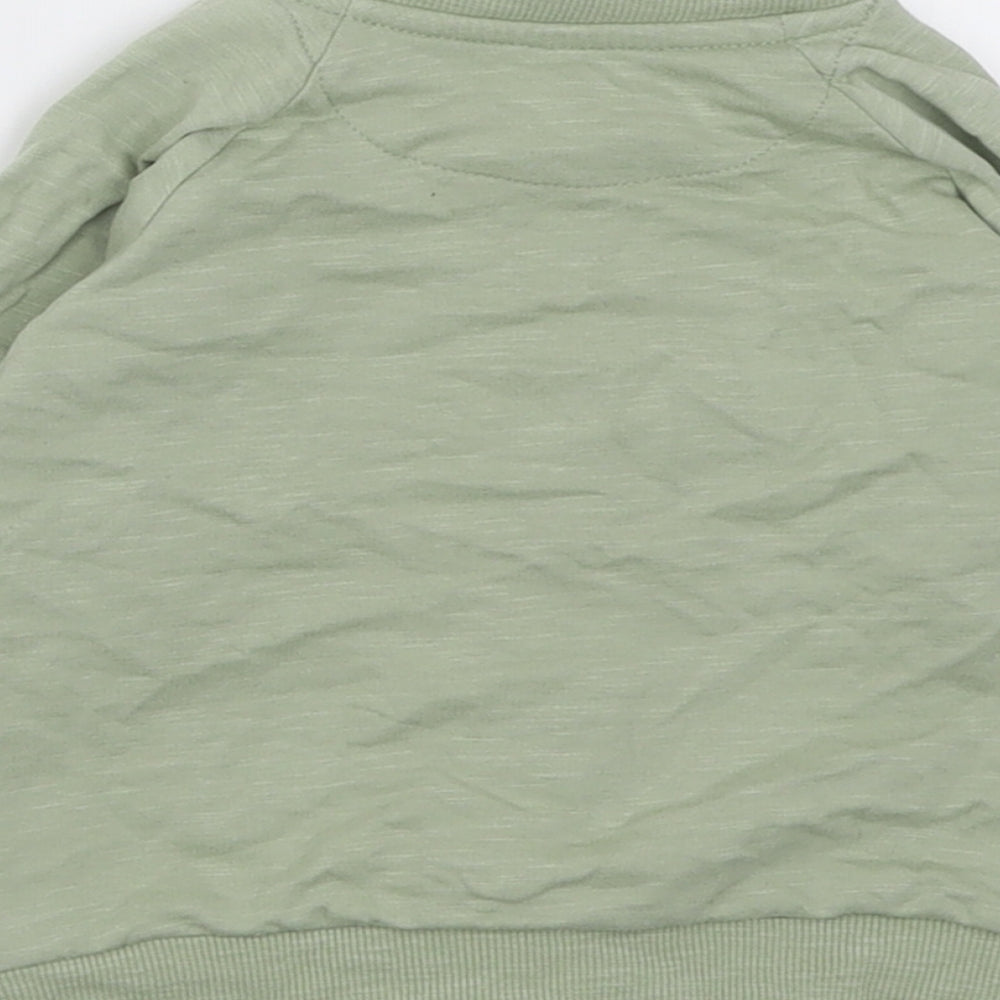 Brand and care label for Matalan girls’ green jacket, size 9-12, months zip