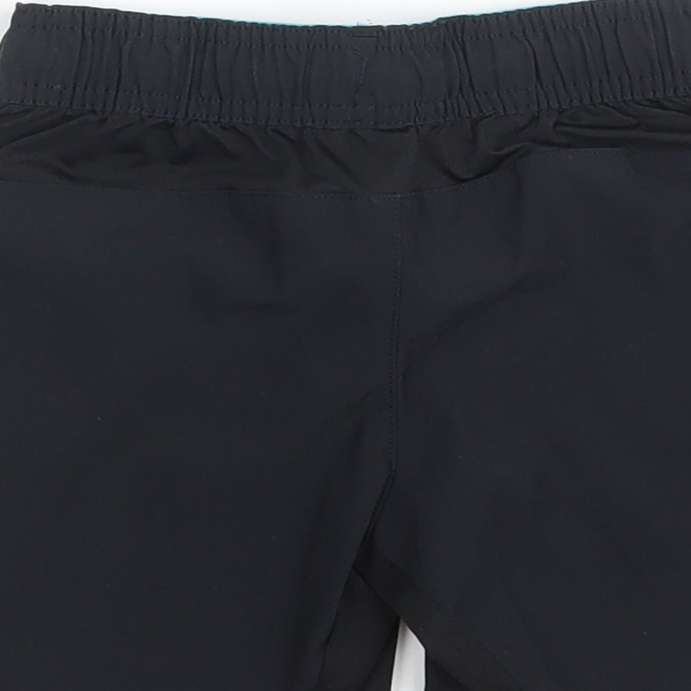 Brand and care label for Domyos boys’ black polyester sweat shorts, size 5, years regular