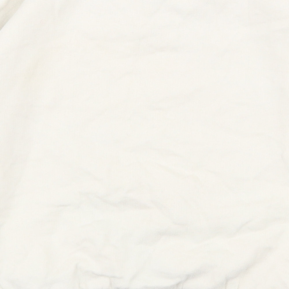 Brand and care label for Tu girls’ white cotton pullover sweatshirt, size 5, years pullover