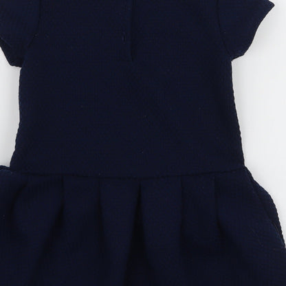 Brand and care label for Next girls’ blue polyester a-line, size 3-4, years round neck pullover