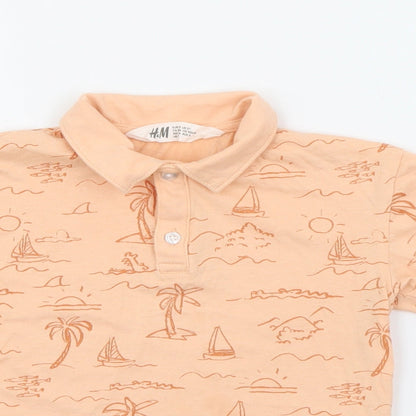 Close-up detail of H&M boys’ orange geometric cotton pullover polo, size 3, years collared button