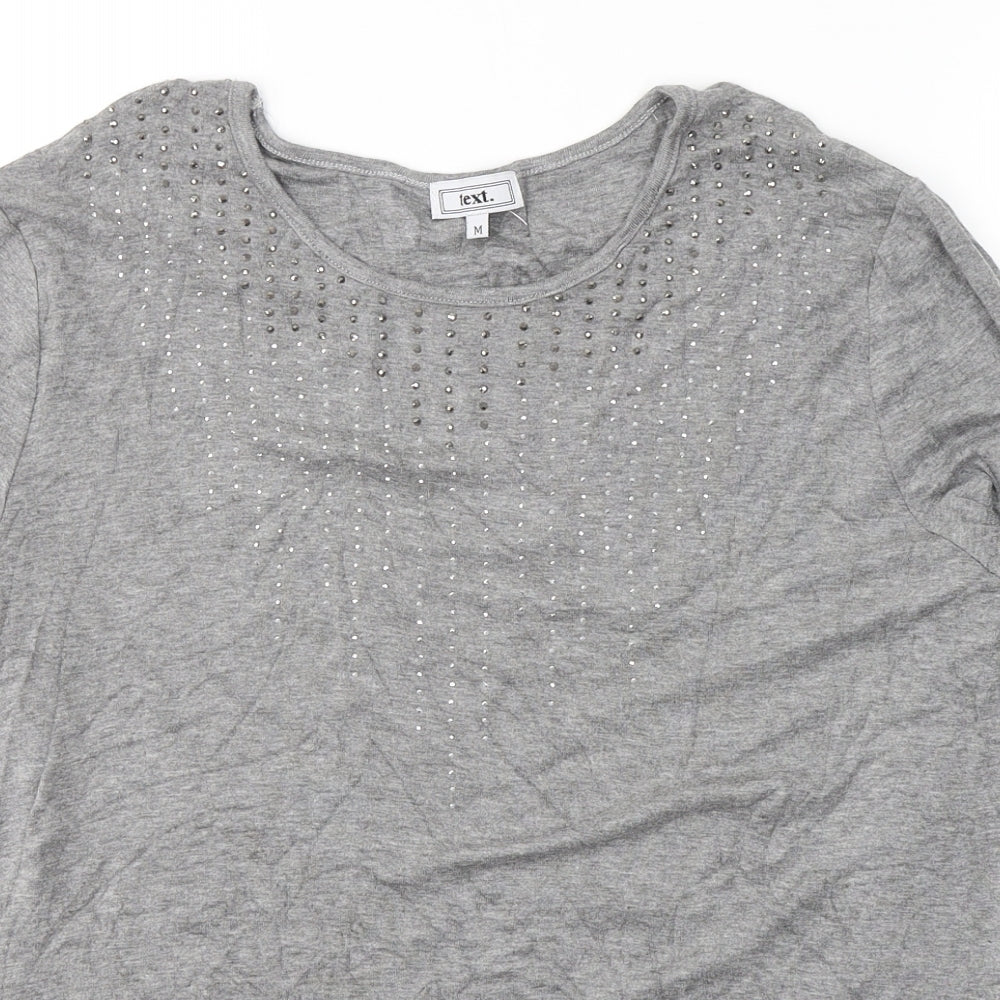 Close-up detail of text. women’s grey viscose jersey blouse, size M, round neck