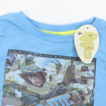 Close-up detail of Peacocks boys’ blue cotton basic t-shirt, size 6-9, months crew neck pullover - awesome monkey