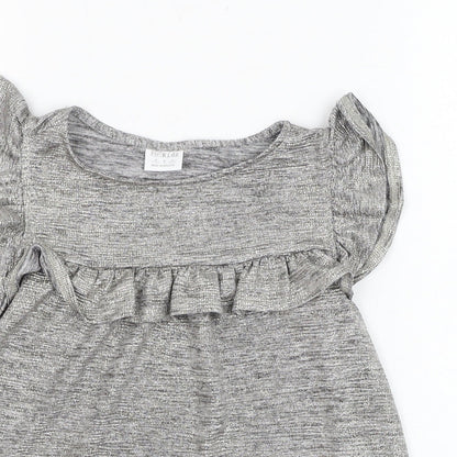 Close-up detail of F&F girls’ silver polyester basic blouse, size 9-10, years round neck pullover