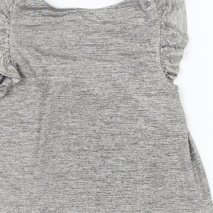 Brand and care label for F&F girls’ silver polyester basic blouse, size 9-10, years round neck pullover