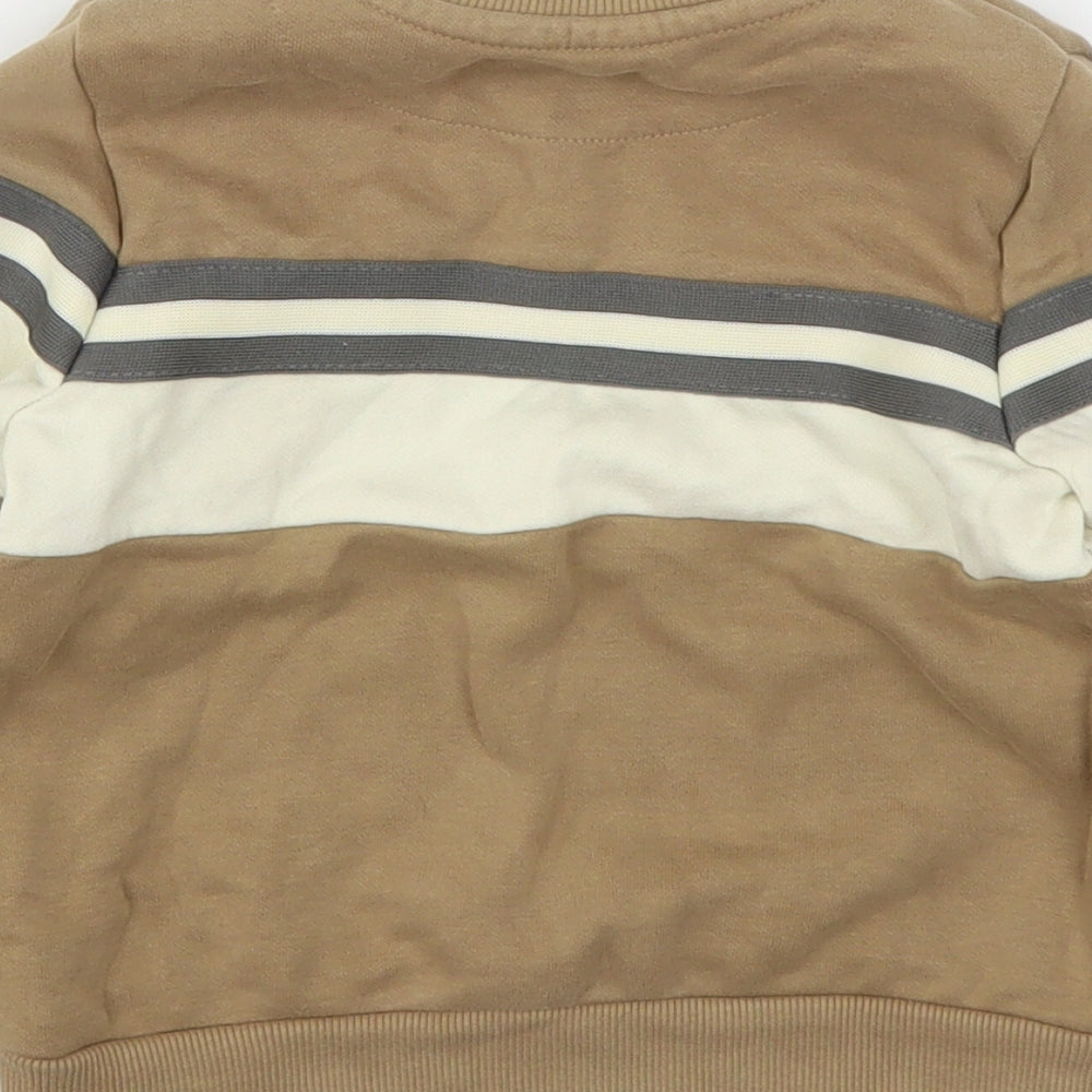 Brand and care label for Nutmeg boys’ brown cotton pullover sweatshirt, size 2-3, years