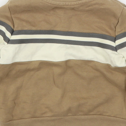 Brand and care label for Nutmeg boys’ brown cotton pullover sweatshirt, size 2-3, years