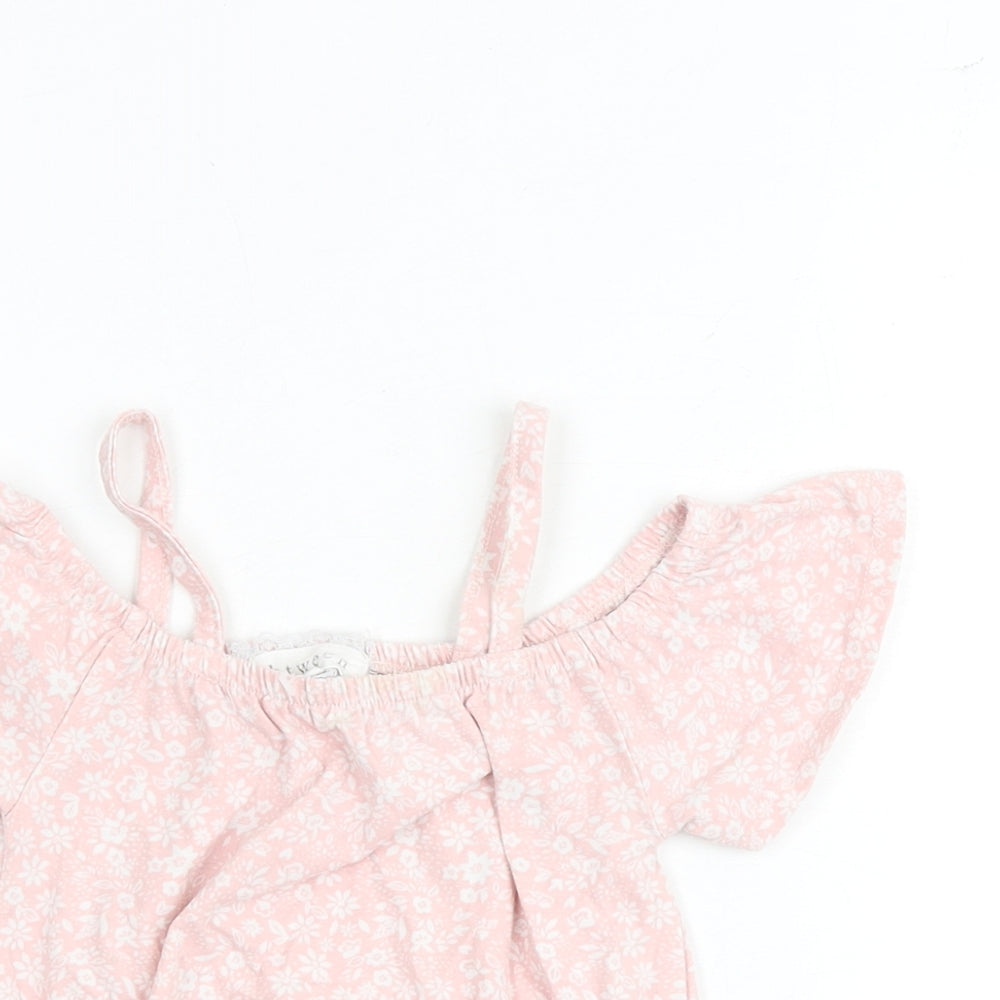 Close-up detail of Btween girls’ pink floral cotton basic blouse, size 6, years round neck pullover - cold shoulder