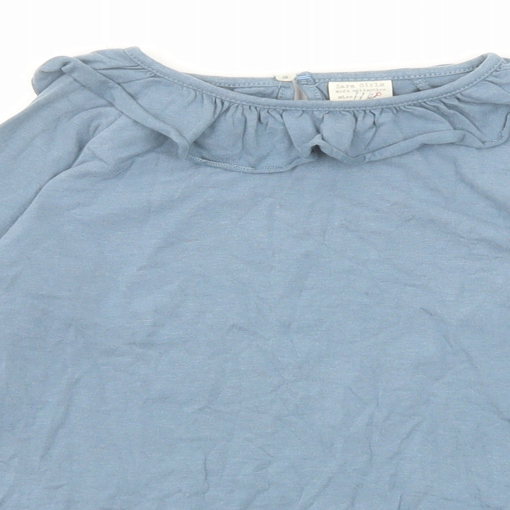 Close-up detail of Zara girls’ blue polyester basic t-shirt, size 8, years round neck button