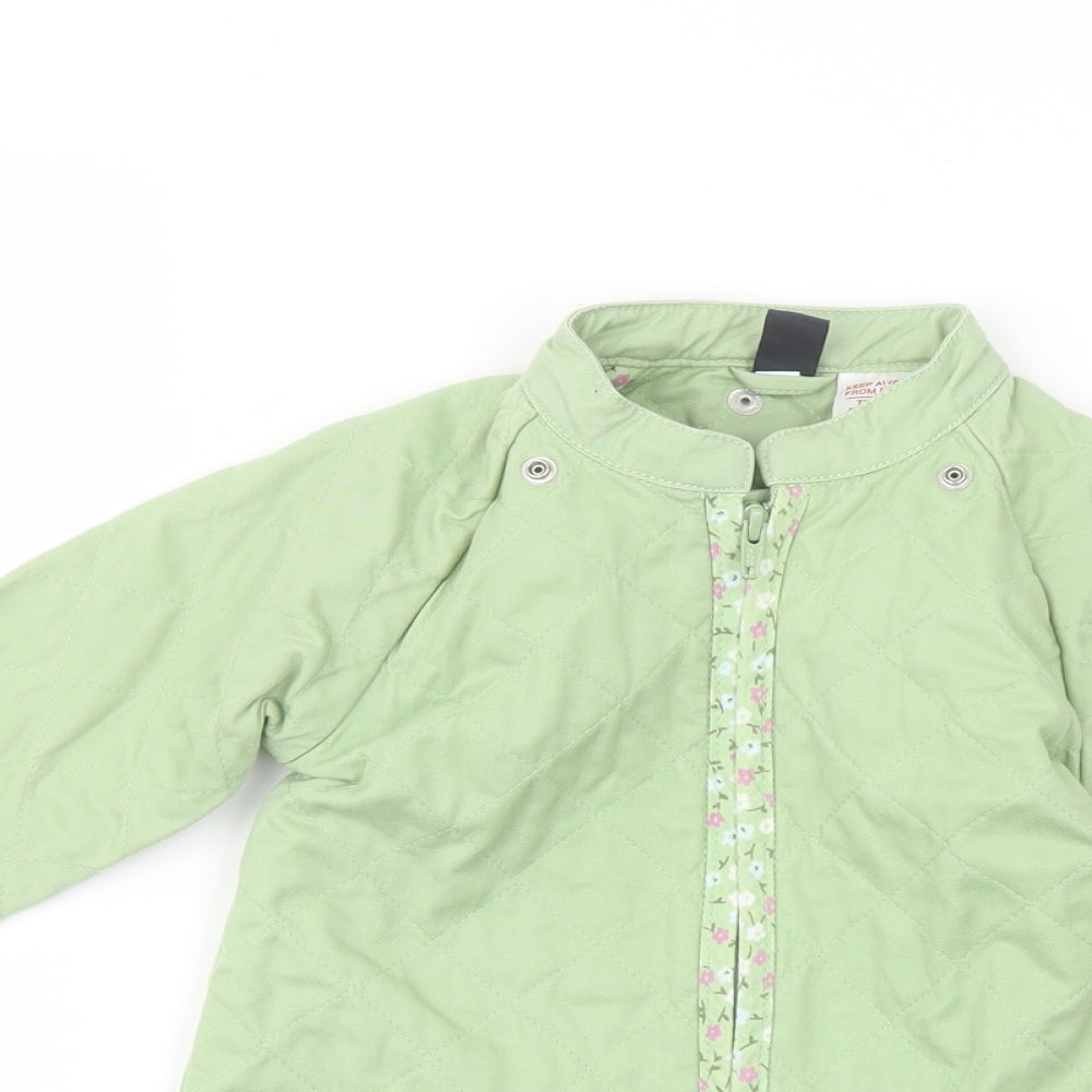 Close-up detail of Gap girls’ green jacket, size 3, years zip