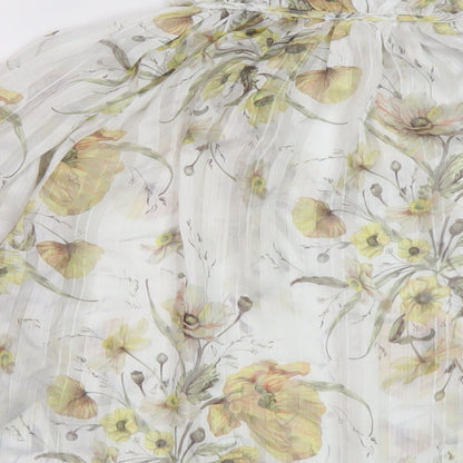 Brand and care label for H7&M women’s white floral polyester basic blouse, size UK 6, mock neck