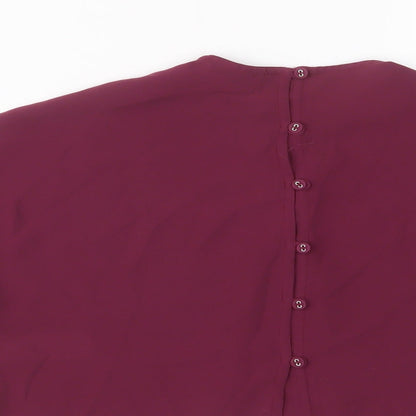 Brand and care label for Next girls’ purple polyester basic t-shirt, size 6, years crew neck button