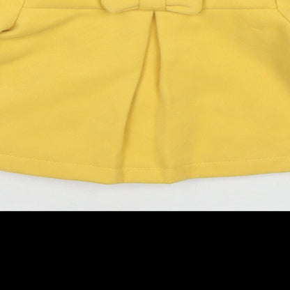 Brand and care label for Maxx girls’ yellow pea coat coat, size 12, months button