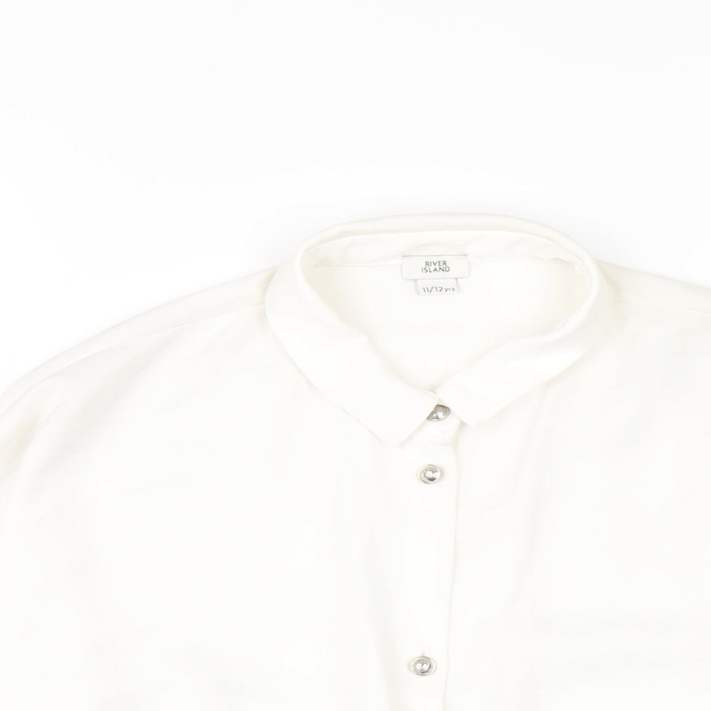 Close-up detail of River Island girls’ white polyester basic button-up, size 11-12, years collared button