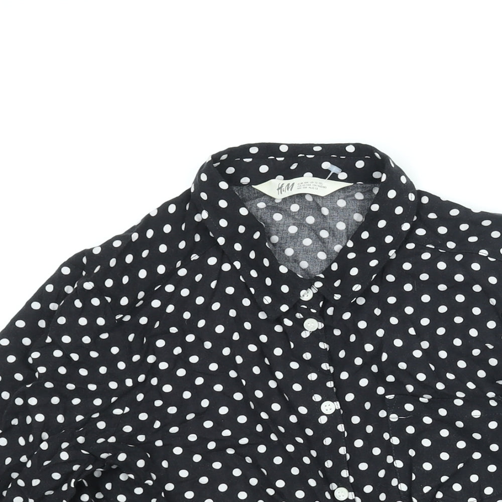 Close-up detail of H&M girls’ black polka dot viscose basic button-up, size 13, years collared button - tie detail
