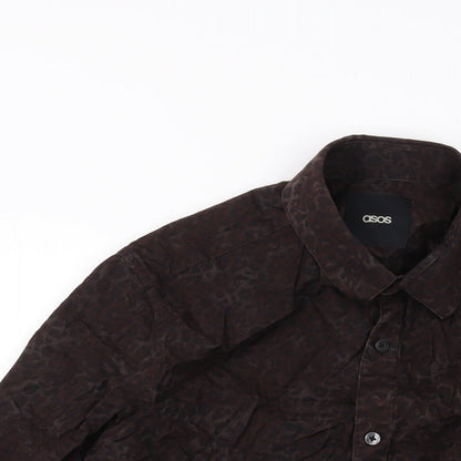 Close-up detail of ASOS men’s brown animal print cotton button-up, size M, collared button