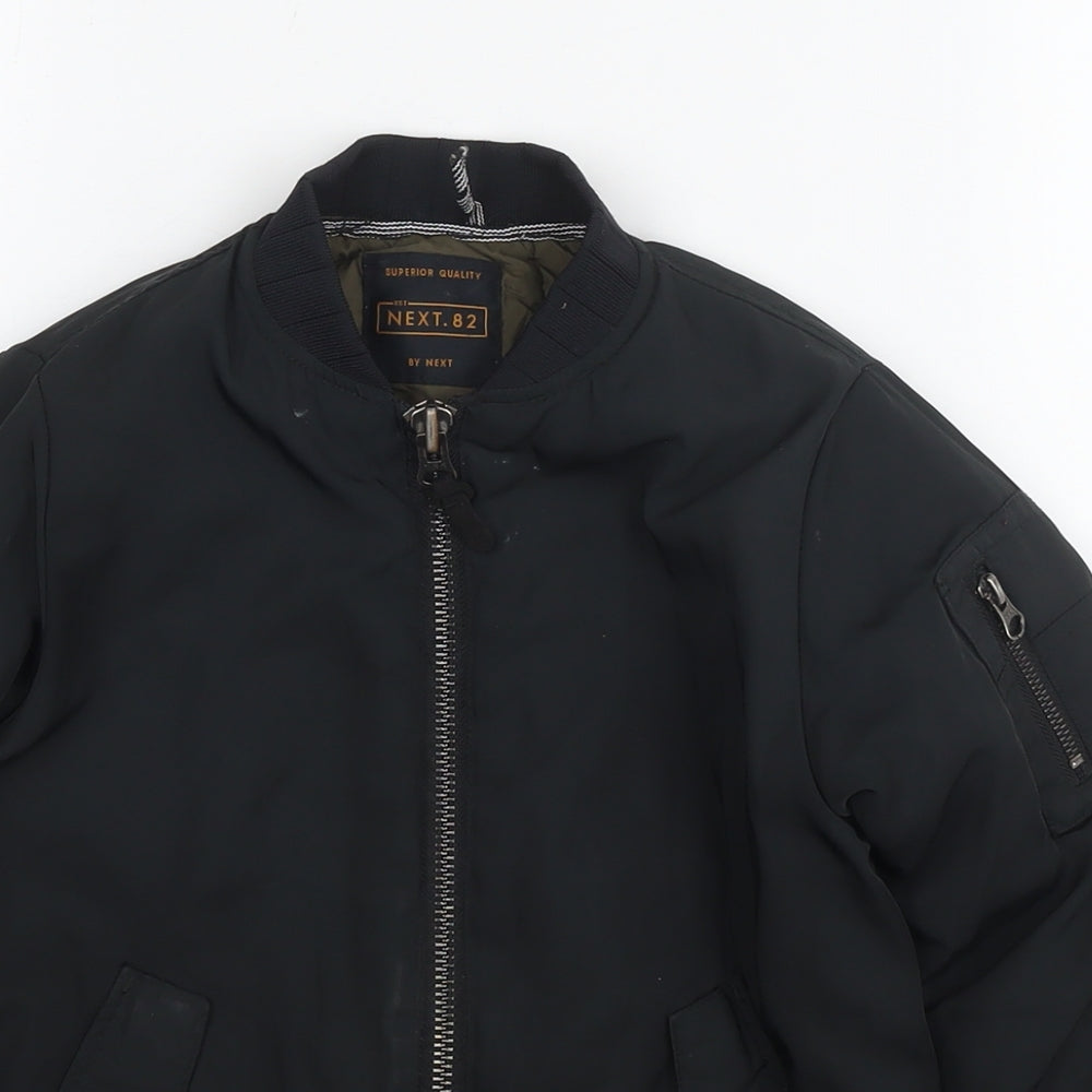 Close-up detail of Next boys’ black jacket, size 6, years zip